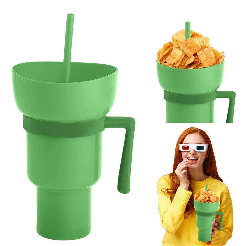 Green cup with handle and straw, filled with chips, and a person holding it.