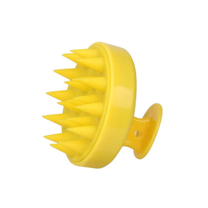 Yellow scalp massager on a white background