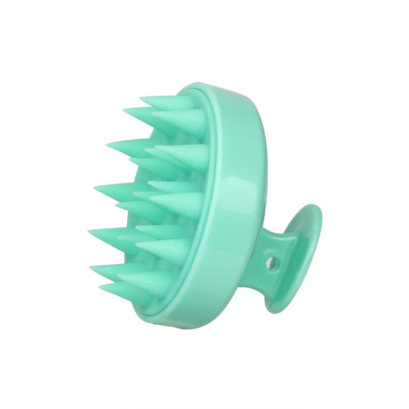 Turquoise silicone scalp massager on a white background