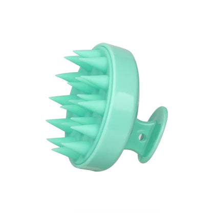 Turquoise silicone scalp massager on a white background