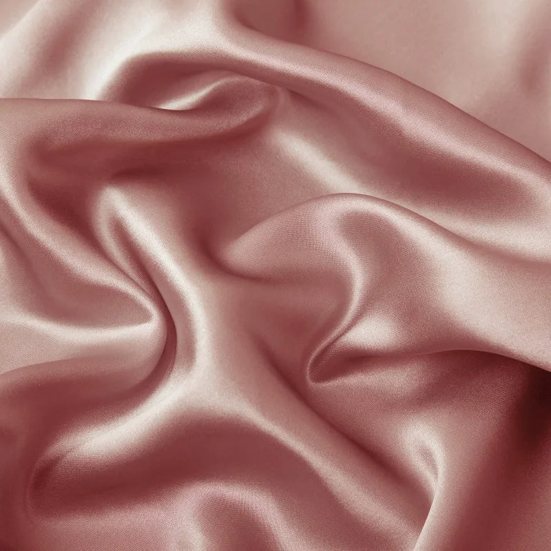 Close-up of pink satin fabric with soft folds
