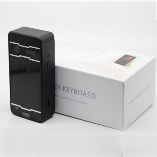 Black keyboard device next to its packaging box on a white background