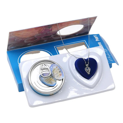 Jewelry set with heart-shaped pendant and circular case in a box on a white background