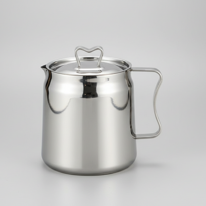 Stainless steel pitcher on a gray background