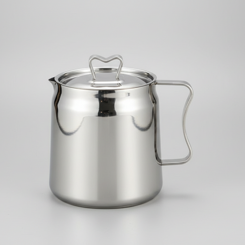 Stainless steel pitcher on a gray background