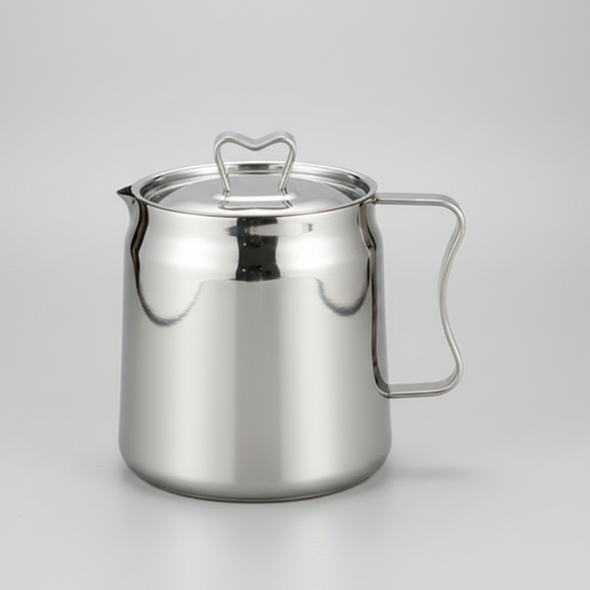 Stainless steel pitcher on a gray background
