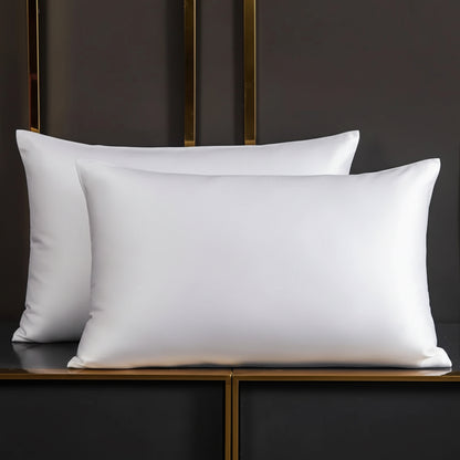 White pillows on a dark wooden shelf.