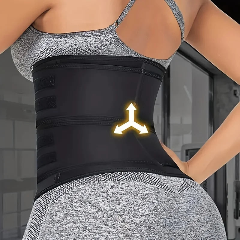 Person wearing a black waist trainer with a logo, standing against a blurred indoor background.