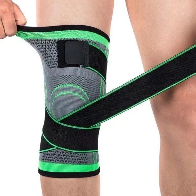 Knee brace with green and black straps being worn on a person's knee.