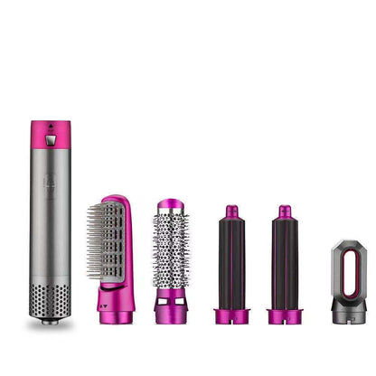 Set of hair styling tools with pink and silver accents on a white background