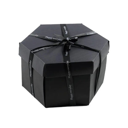 Black gift box with a ribbon on a white background