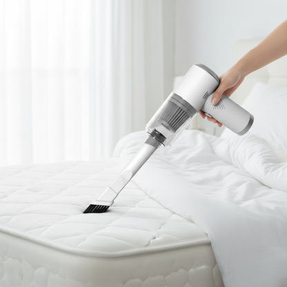 Handheld vacuum cleaner cleaning a mattress on a white background
