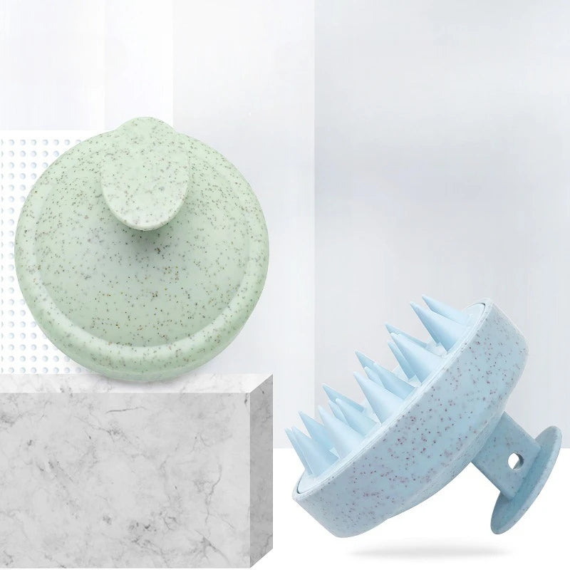 Two green and blue scalp massagers on a white background