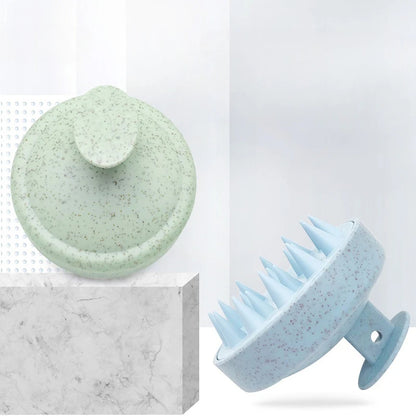 Two green and blue scalp massagers on a white background