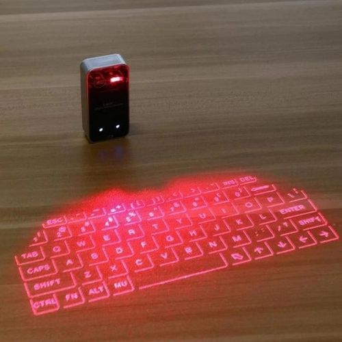 Virtual Laser Keyboard projector displaying a virtual keyboard on a wooden surface