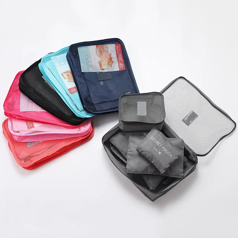 Set of travel packing cubes in various colors on a white background