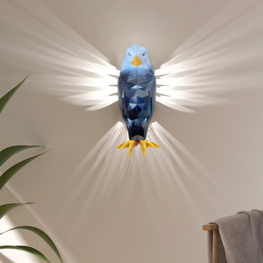 Blue bird-shaped lamp on a beige wall with a plant and towel in the corner.