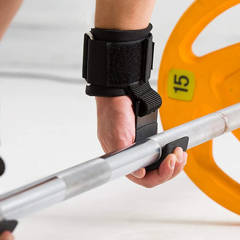 Hand holding a weightlifting bar with a wrist support, weight plate in the background