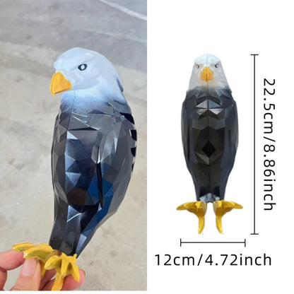 Geometric eagle toy held by a hand with measurements on a white background
