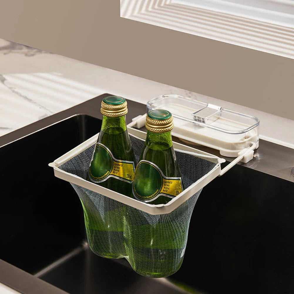 Two green bottles in a transparent bottle holder on a kitchen counter.