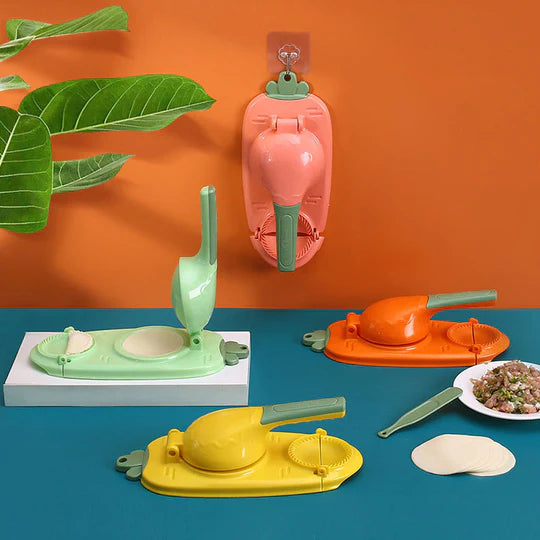 Set of colorful dumpling makers on a blue surface with an orange wall in the background.
