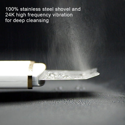 Stainless steel shovel with dust being blown away on a dark background