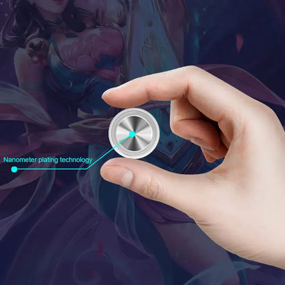 Hand holding a metallic spinner with 'Nanometer plating technology' text on a blurred fantasy-themed background