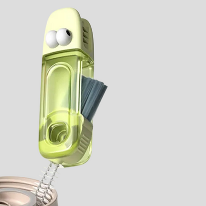 Green cleaning brush with a cartoon face on a white background
