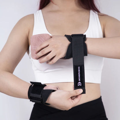Person wearing black wrist wraps with a visible brand logo on a white background