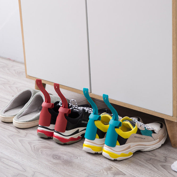 Colorful shoes with unique sole designs on a wooden floor.