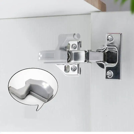 Metallic cabinet hinge on a white surface with an inset showing a close-up of the hinge.