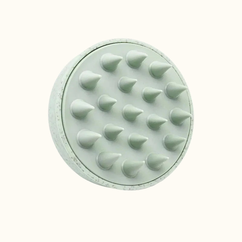 Mint green silicone scrubber with textured surface on a white background