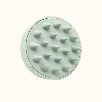 Mint green silicone scrubber with textured surface on a white background