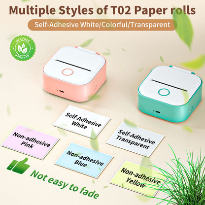 Two small devices with self-adhesive paper rolls on a light background with greenery.