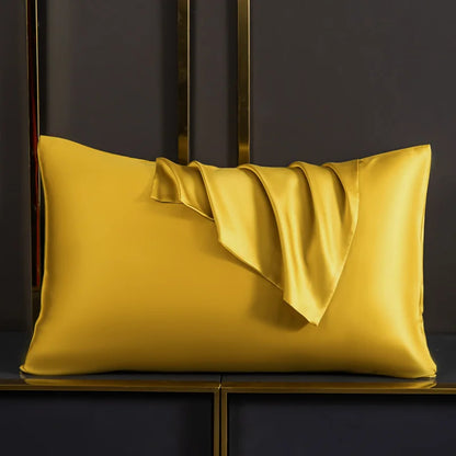 Gold satin pillow on a dark background