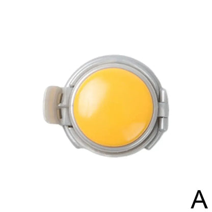 Round yellow object with metallic rim on a white background