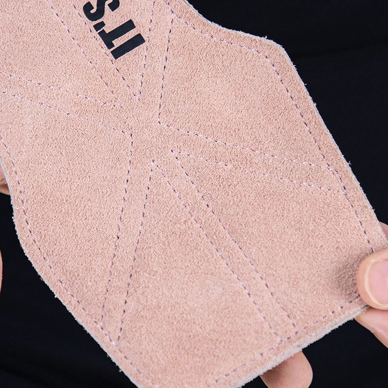 Close-up of a beige leather glove with 'ST' branding on a black background