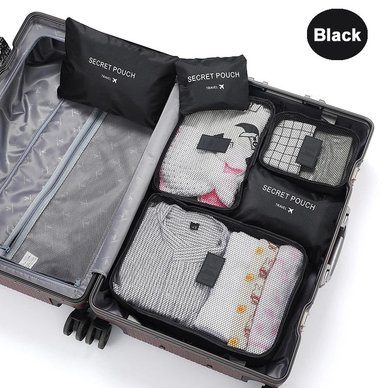 Black travel packing cubes with 'Secret Pouch' labels inside an open suitcase.