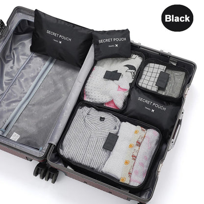 Black travel packing cubes with 'Secret Pouch' labels inside an open suitcase.