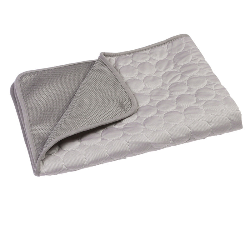 Gray quilted blanket with textured surface on a white background