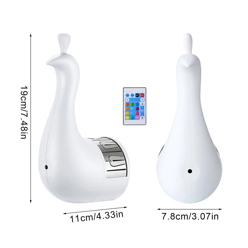 White peacock-shaped night light projector with remote control and measurements on a white background