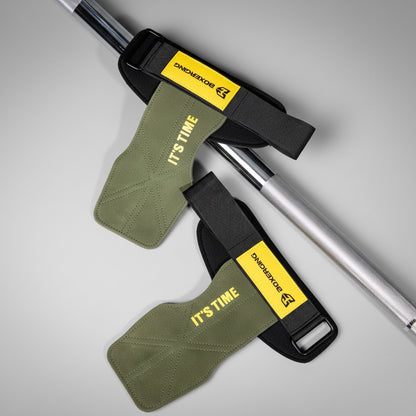 Two green straps with yellow labels on a gray background
