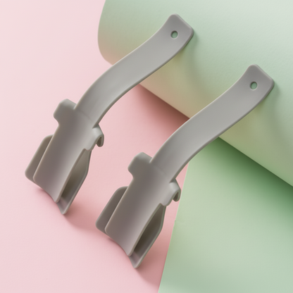 Two yellow plastic clips on a pink and green background