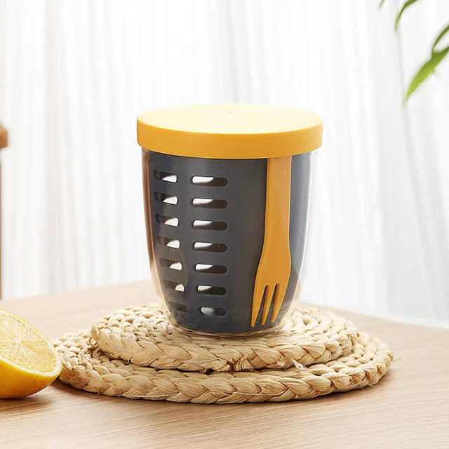 Gray and yellow kitchen tool with a lemon on a woven mat