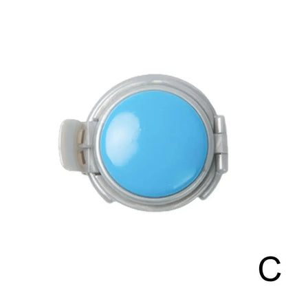 Round blue object with a metallic rim on a white background