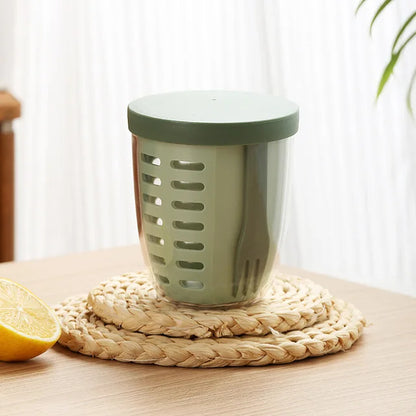 Green kitchen strainer on a woven mat with a lemon next to it