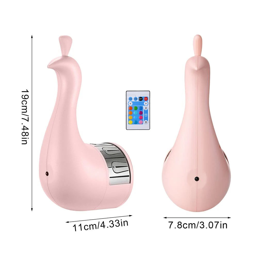 Pink peacock-shaped night light projectior with remote control and measurements on a white background