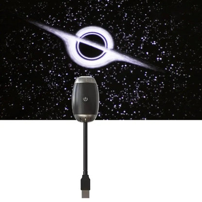 Black electronic device with USB cable against a space-themed background