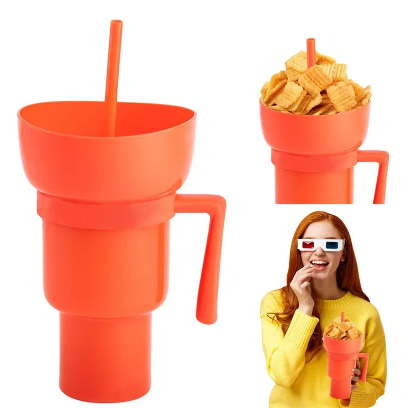 Orange cup with handle and straw, filled with snacks, and a person holding it.