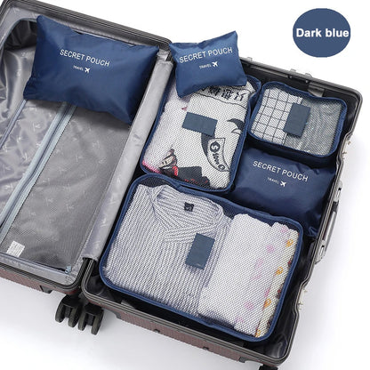 Open suitcase with travel packing cubes labeled 'Secret Pouch' on a white background.